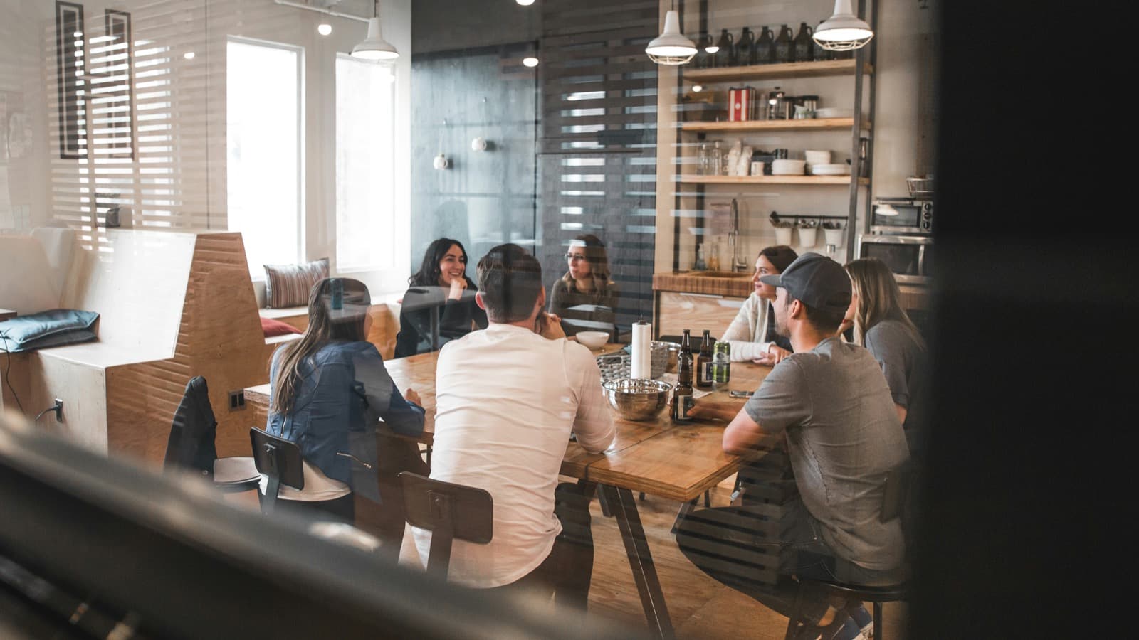 Small agency team in office discussing HR management and team operations