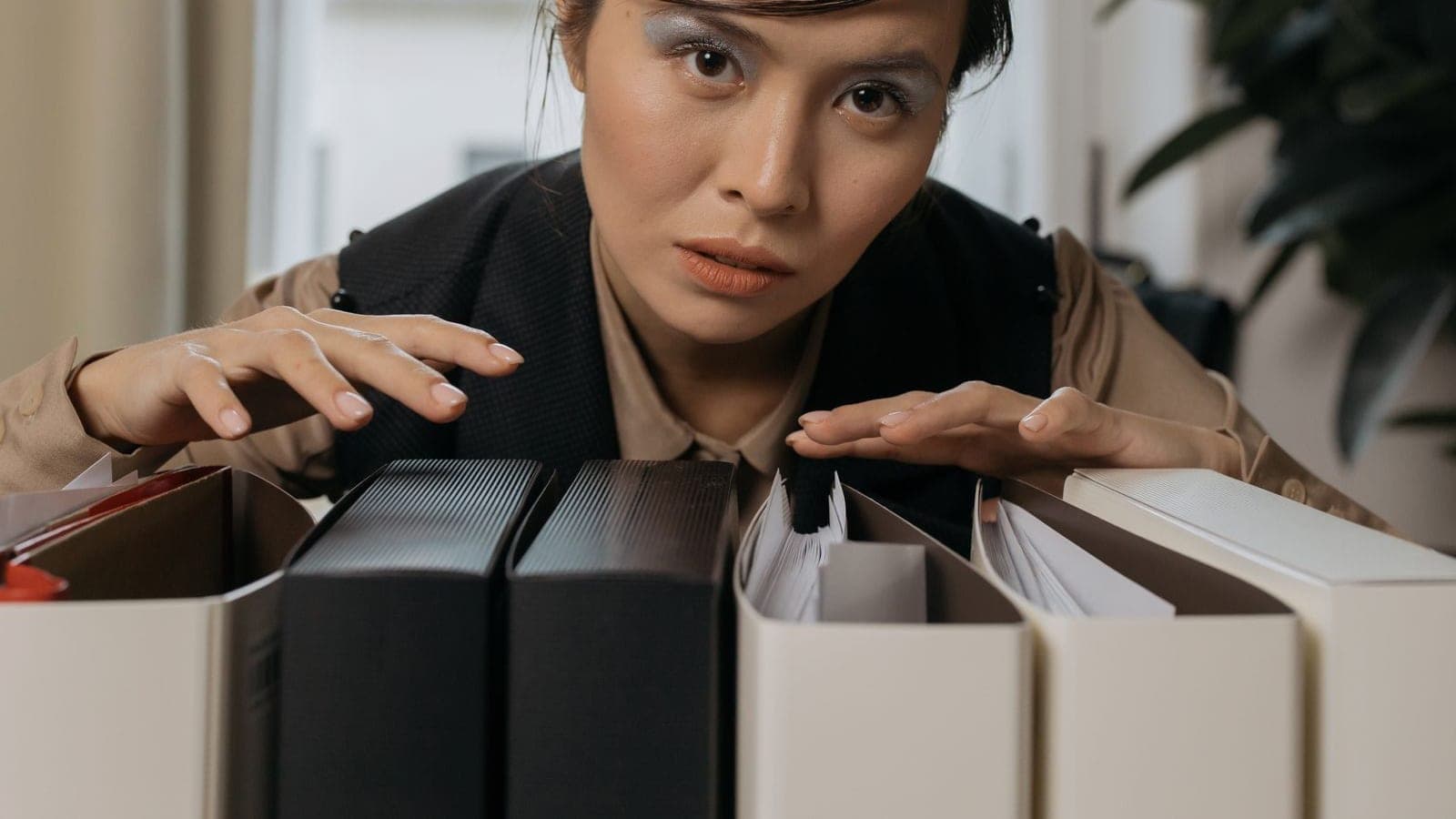 Team member digging through boxes of file folders looking for a document
