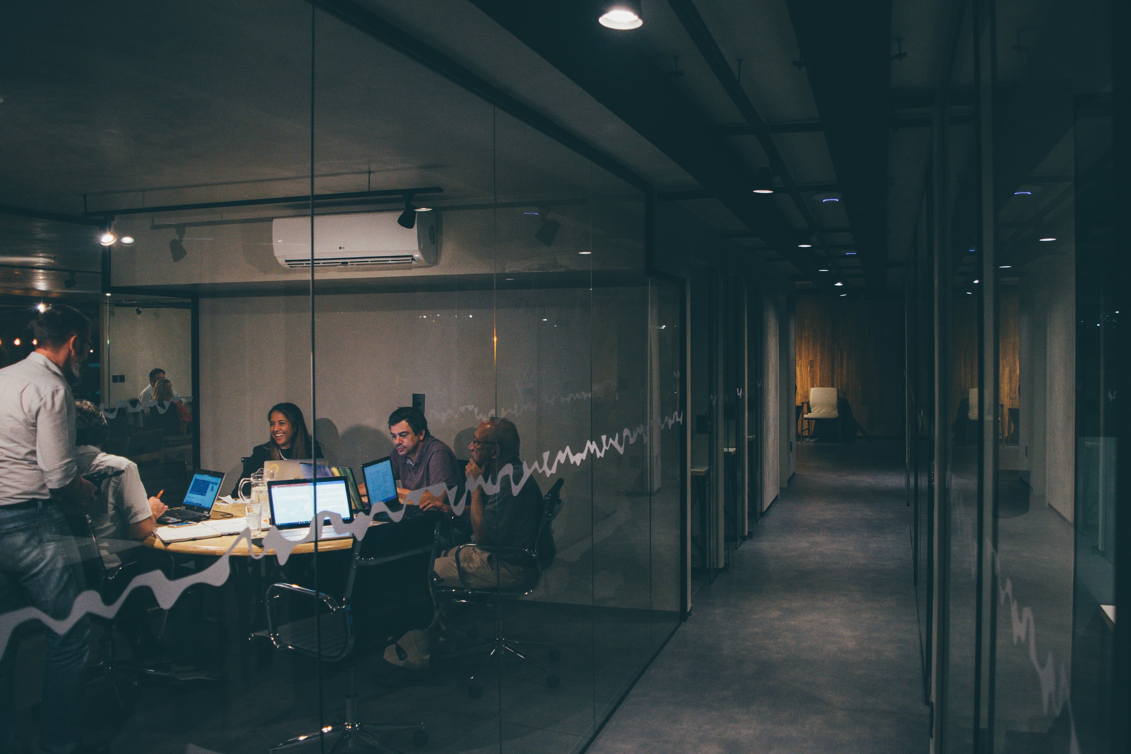 Growing agency team working together in a modern office showing the challenges of scaling from a small to mid-size team